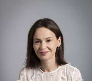 Kate Russell, woman wearing white blouse with dark hair and brown eyes