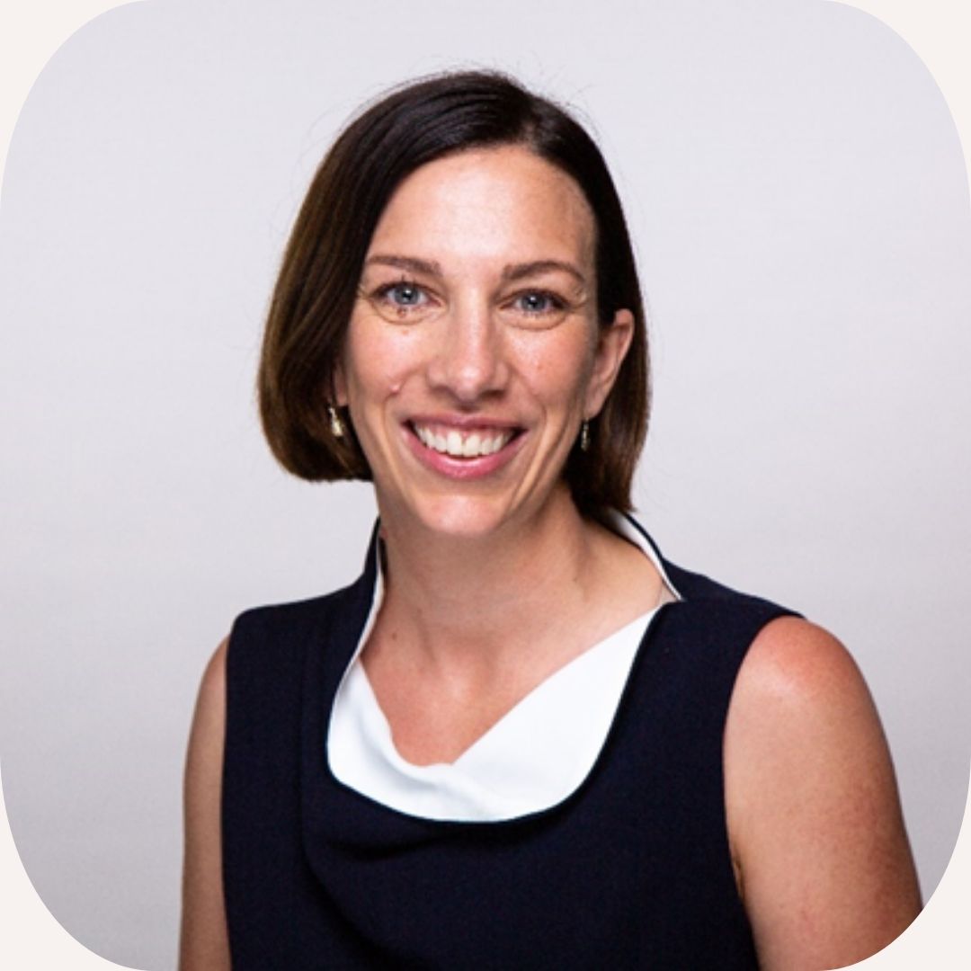 Headshot of Louise Monger who wears a black and white top and has a dark brown bob haircut.