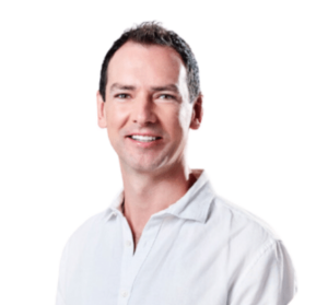 Image of Ashley, wearing a white button up shirt and has dark short hair