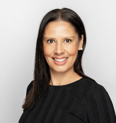 Bronwyn Dodd - a woman with long brown hair wearing a black blouse smiling at the camera.
