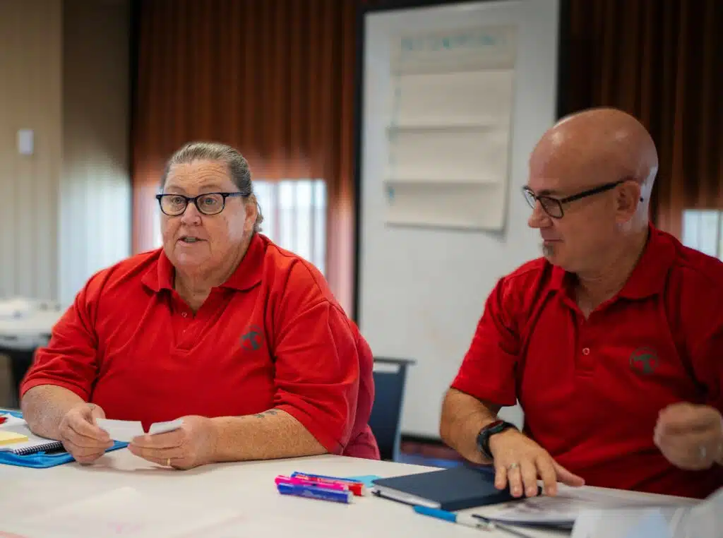 Two Bunnings employees having a conversation in an office